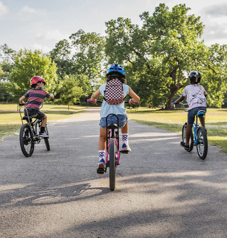 Children in Romania with donated bicycles and books.