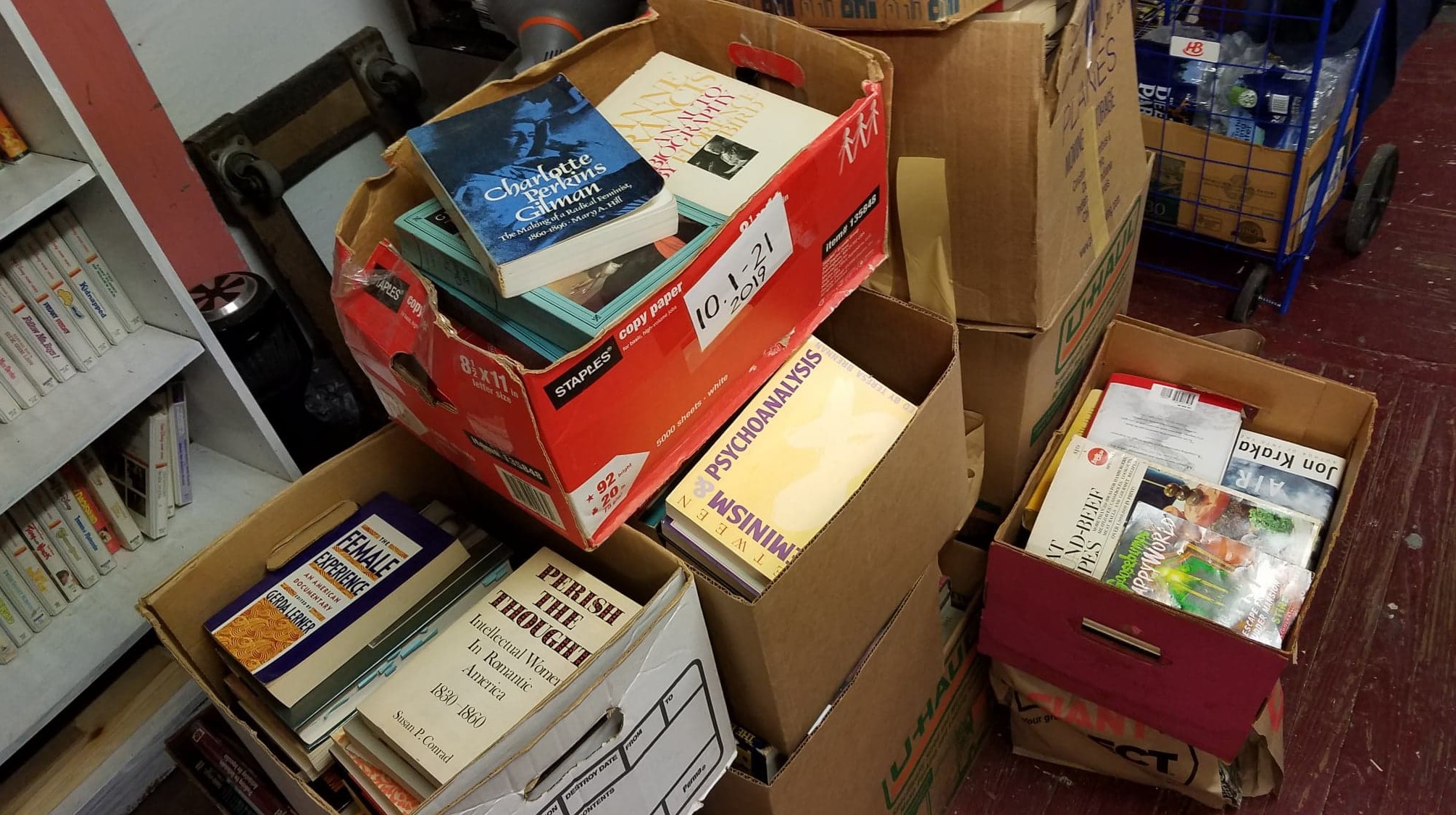 Stack of donated books and school supplies.