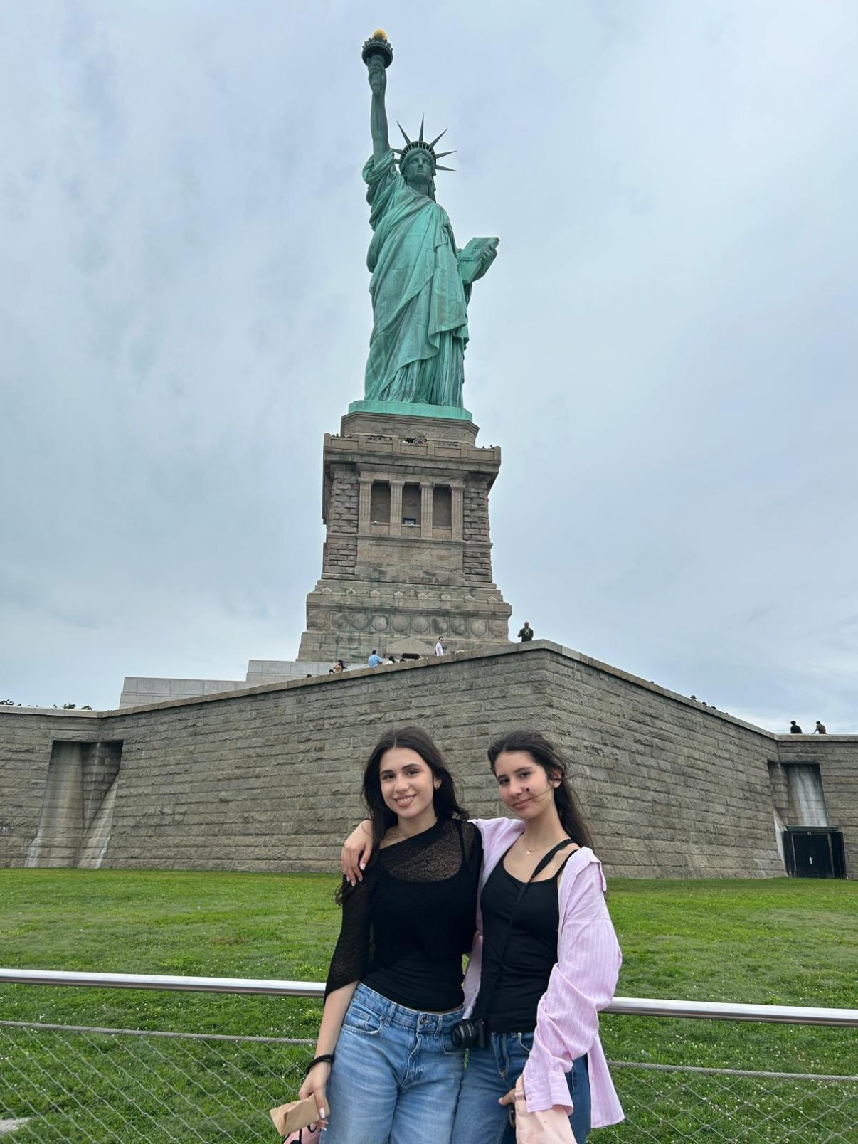 Two students from the U.S. Education Trip in front of the Statue of Liberty.