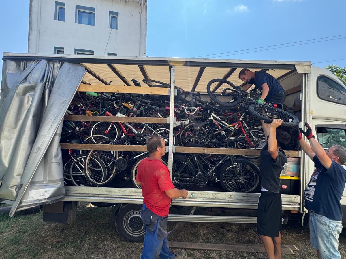 Volunteers unloading bicycles from the truck after it arrived in Romania.