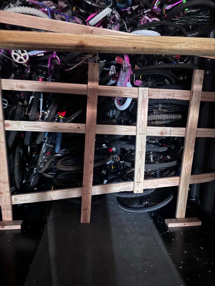 A close-up view of bicycles secured on the shelving inside the shipping container.