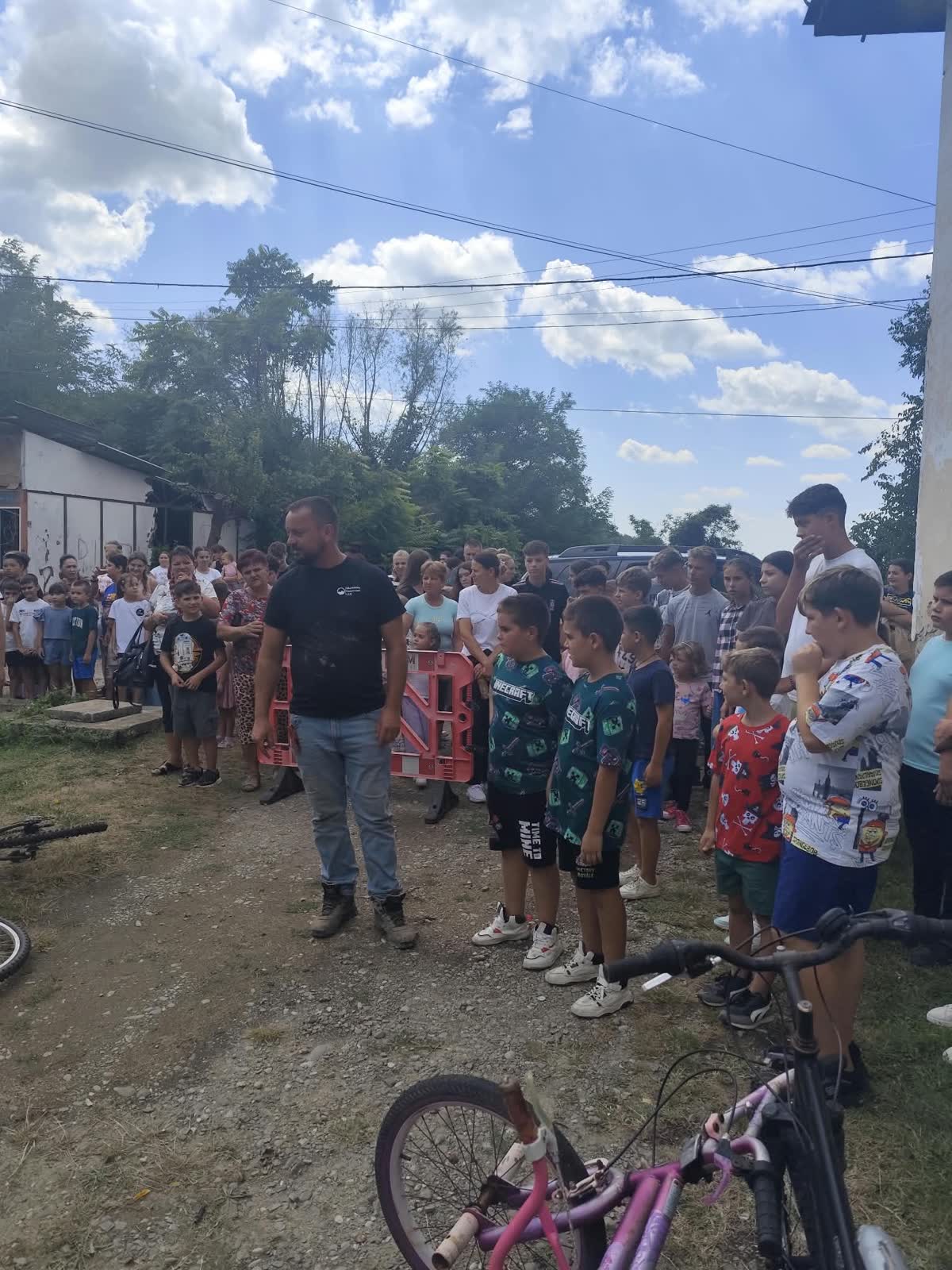 A large crowd of children and families gathered to receive bicycles.