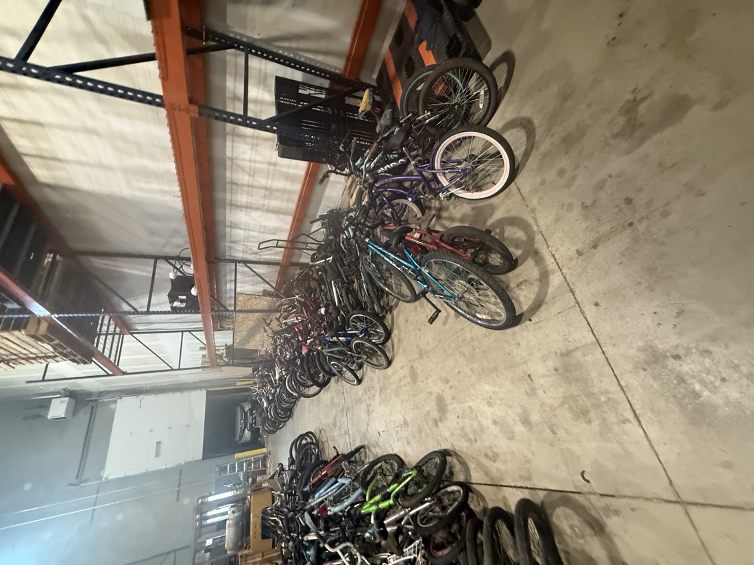 The first set of bicycles unloaded and staged on the floor of a logistics warehouse.