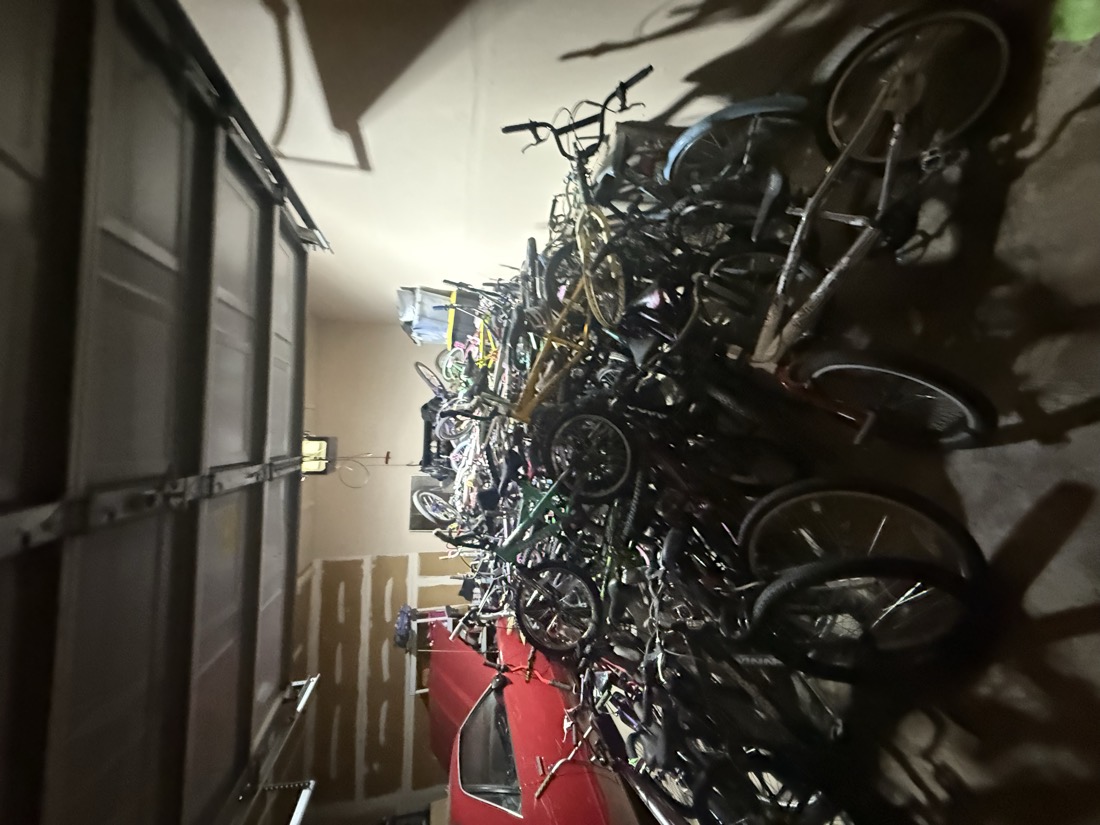 A close-up view of the garage completely full of donated bicycles.
