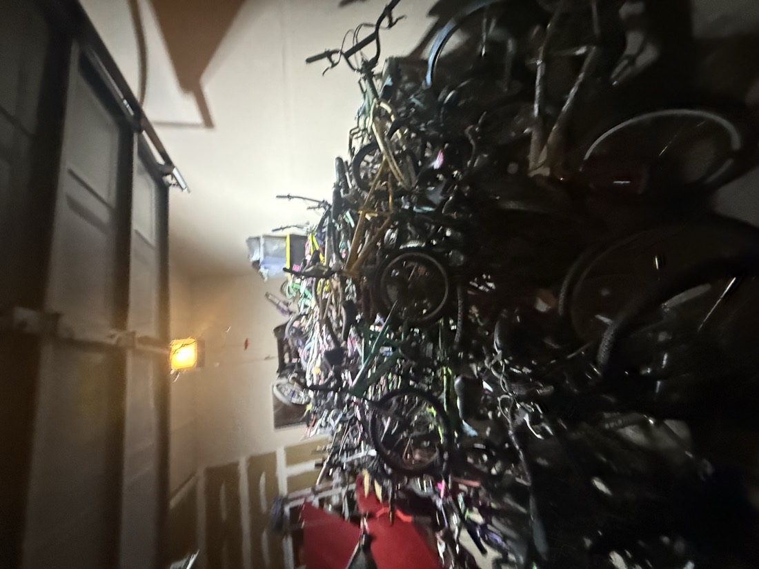 Dozens of donated bicycles of every size and color packed into the garage.